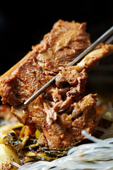 Korean pork rib dish, eating with chopsticks 