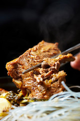 Korean pork rib dish, eating with chopsticks 