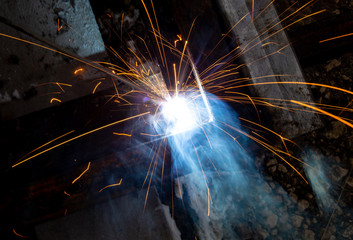 Fototapeta na wymiar sparks from metal welding at a construction site