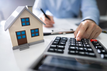Businessman's Hand Calculating Invoice