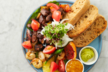 Beef steak, fruit, bread sauce on plate 