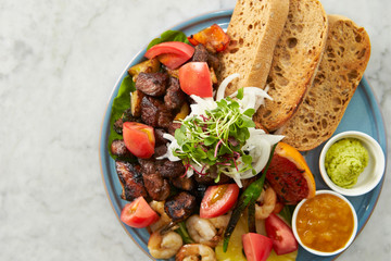 Beef steak, fruit, bread sauce on plate 