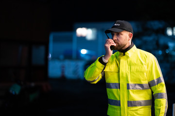 Young Security Guard Talking On Walkie-talkie