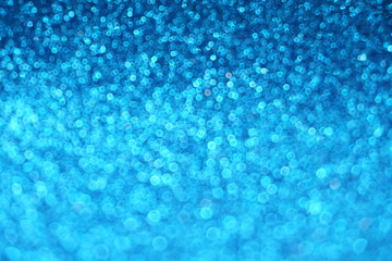 Abstract defocused shiny sparkle blue glitter bokeh background