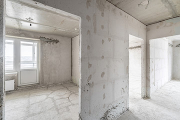 Empty interior for design, gray concrete wall. Empty room. Space for text and picture. Concrete walls, slabs, interior of a new residential building. Partitions in a new apartment.