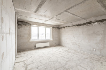 Empty interior for design, gray concrete wall. Empty room. Space for text and picture. Concrete walls, slabs, interior of a new residential building. Partitions in a new apartment.