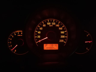 Orange light meter of car in night.An electronic odometer with digital display 044444 km.Display ...