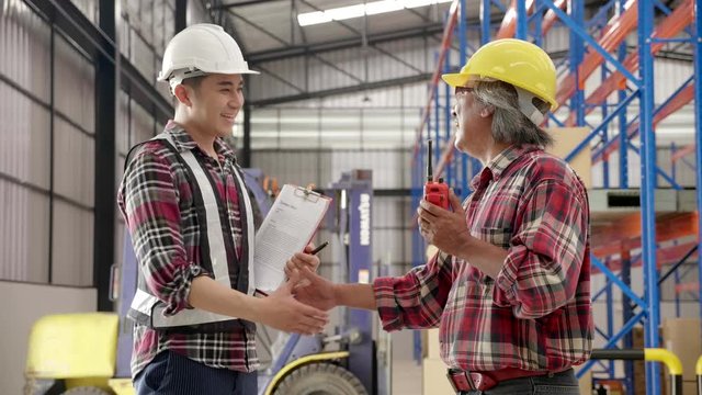 Asian contractors talking to businessmen or engineering leaders Wear a helmet to protect against safety and handshake. Cooperate with the construction business. Confidence Trust in working as a team