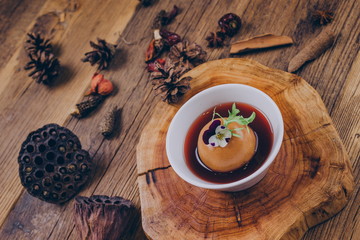 Homemade dessert, a traditional Chinese snack stewed in sugar water with snow pear, in a white bowl.