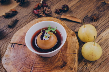 Homemade dessert, a traditional Chinese snack stewed in sugar water with snow pear, in a white bowl.