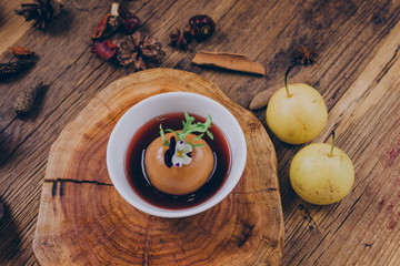 Homemade dessert, a traditional Chinese snack stewed in sugar water with snow pear, in a white bowl.