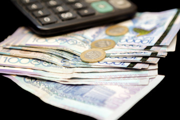 Calculator and money. Money of the Kazakh national currency in tenge with a face value of 10,000...