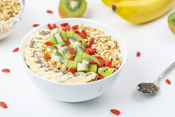 Healthy summer breakfast. Smoothie bowl with granola, banana, kiwi, chia seeds and Goji berry.