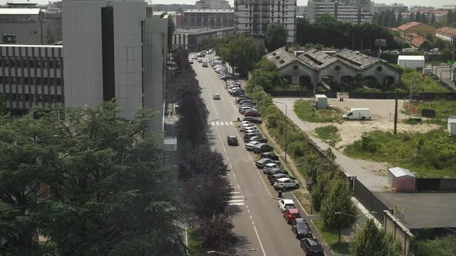 MILAN, ITALY &ndash; JUNE 2019: Handheld shot panoramic view from white building Milano center shot with cars moving. Top view shot of Milano road from the top of the white building, Prada Foundation