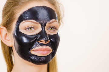 Girl black carbo peel off mask on face