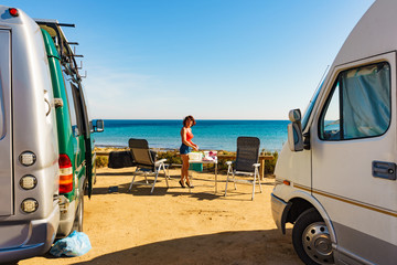 Woman wash dishes in bowl, capming outdoor