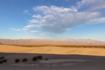 clouds above sand dunes in desert of Death Valley National Park, California