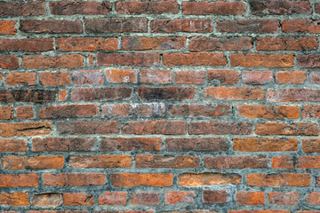 Fototapeta premium Weathered old red brick background with rough surface.