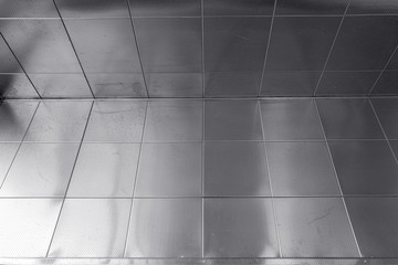 Shiny Metal Perforated Tiles in a Corner