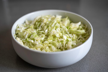 Cabbage salad on white bowl.