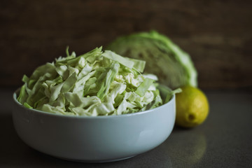 Chopped cabbage in white bowl. A raw food diet.