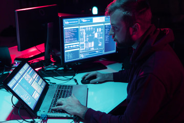 Wanted hackers coding virus ransomware using laptops and computers in the basement. Cyber attack,...