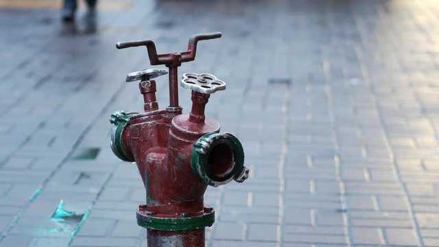 Fire hydrant ready to connect hose during fire fighting outdoors. Old red fire hydrant 4k