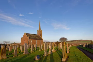 Fotobehang St Cyrus Parish church set back from the Cliffs of this old Fishing Village, with its simple design and extensive Graveyard in Winter. © Julian