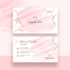 Front and back view of business card design with pink brush stroke and geometric elements.