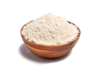 Whole flour in wooden bowl, isolated.