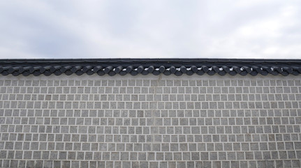 Gray brick wall ancient architecture and Asian black roof construction design at Gyeongbokgung Palace Tourism Landmark in Northern Seoul Korea