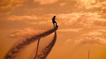 Fotobehang Person propelling through air on flyboard © kustvideo