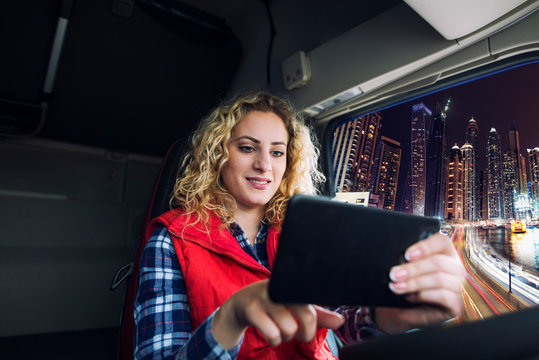 Truck Driver Using GPS Navigation Device To Navigate Through Large City Traffic To Get To The Destination. Navigational Equipment For Trucks.