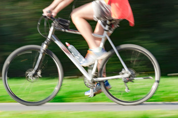 Fototapeta na wymiar Riding bicycle - blurred motion, fast driving.