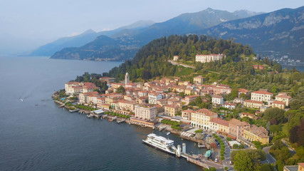Naklejka na ściany i meble Aerial view. In the frame is the famous Italian city of Bellagio. The spa town is located in the center of Lake Como. Ancient villas and houses are inscribed in a beautiful hilly landscape