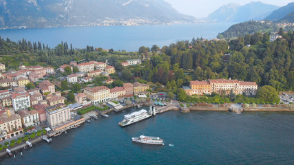 Fototapeta na wymiar Aerial view. In the frame is the famous Italian city of Bellagio. The spa town is located in the center of Lake Como. Ancient villas and houses are inscribed in a beautiful hilly landscape