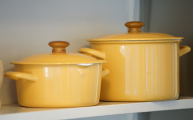 Yellow pan in the shelf of the kitchen