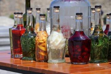 Bottles with alcohols and  fruits. Tincture