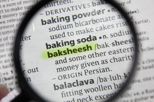 The word or phrase baksheesh in a dictionary.