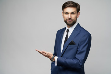 Portrait of a young businessman pointing on a copyspace with his finger - Powered by Adobe