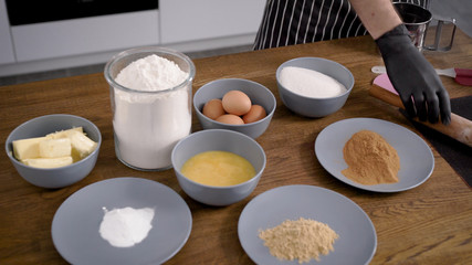 The chef is a pastry chef, laying out ingredients and accessories on the table. Gingerbread will be prepared. Spicy