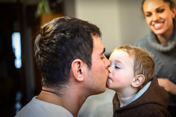 Fototapeta premium Happy young father kissing his sweet adorable baby.