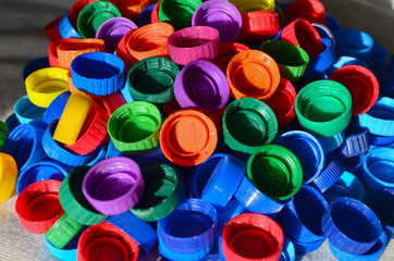 Plastic bottle caps background. Cap material is recyclable.Remove lids from plastic bottles before recycling them. Recycling collection and processing plastic bottle caps