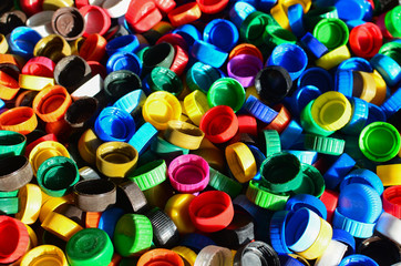 Plastic bottle caps background. Cap material is recyclable.Remove lids from plastic bottles before recycling them. Recycling collection and processing plastic bottle caps