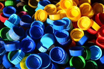 Plastic bottle caps background. Cap material is recyclable.Remove lids from plastic bottles before recycling them. Recycling collection and processing plastic bottle caps