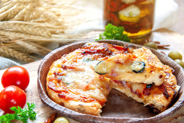 Pizza Diablo pizza with mozzarella and spicy salami on a plate on the table with decorations. Traditional Neapolitan Italian fast food