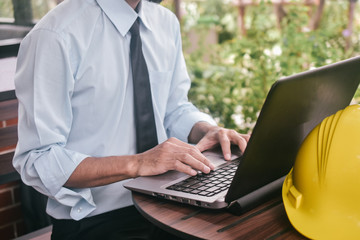 Engineering construction holding computer notebook inspection work at estate building project