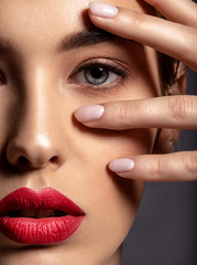 Beautiful woman with bright make-up and red lips.