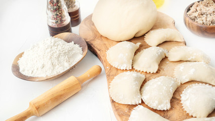 Fototapeta na wymiar Cooking homemade dumplings from raw homemade dough. National cuisine of Slavic peoples