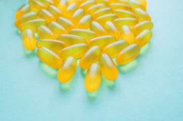 Large medical capsules and tablets-vitamins and nutritional supplements on a blue background. Copy space. Close up. Selective focus